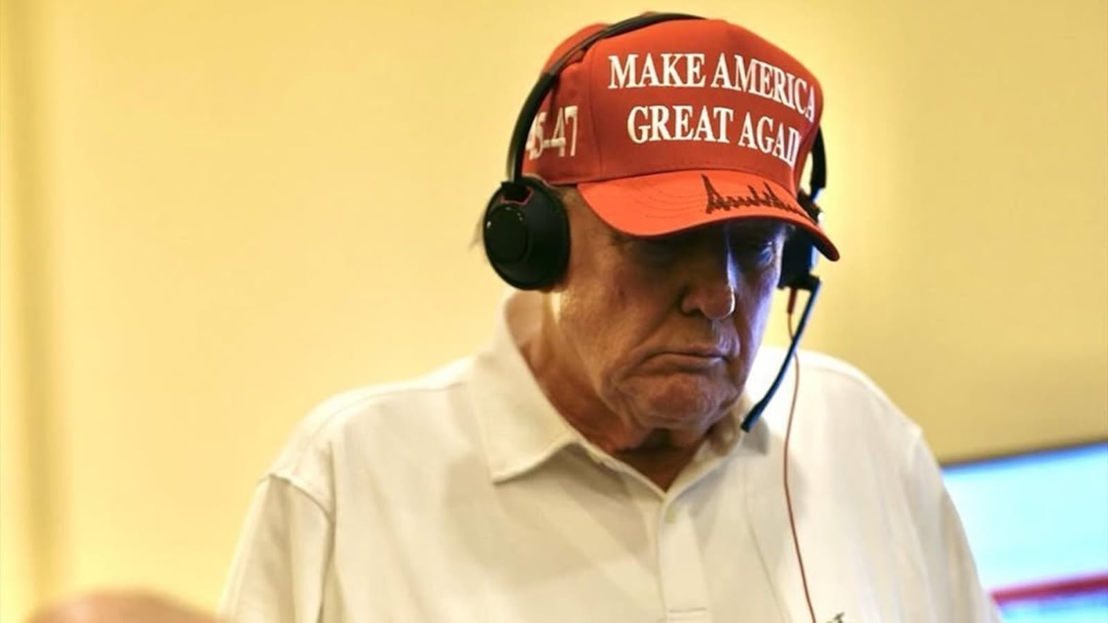 President Donald Trump is shown in a MAGA hat and a Trump golf shirt in a photo posted by the White House, taken at an undisclosed Florida location on Saturday, March 15, 2025.