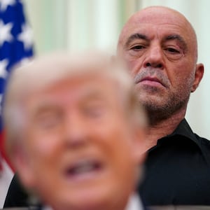 Joe Rogan stands next to U.S. President Donald Trump in the Oval Office of the White House