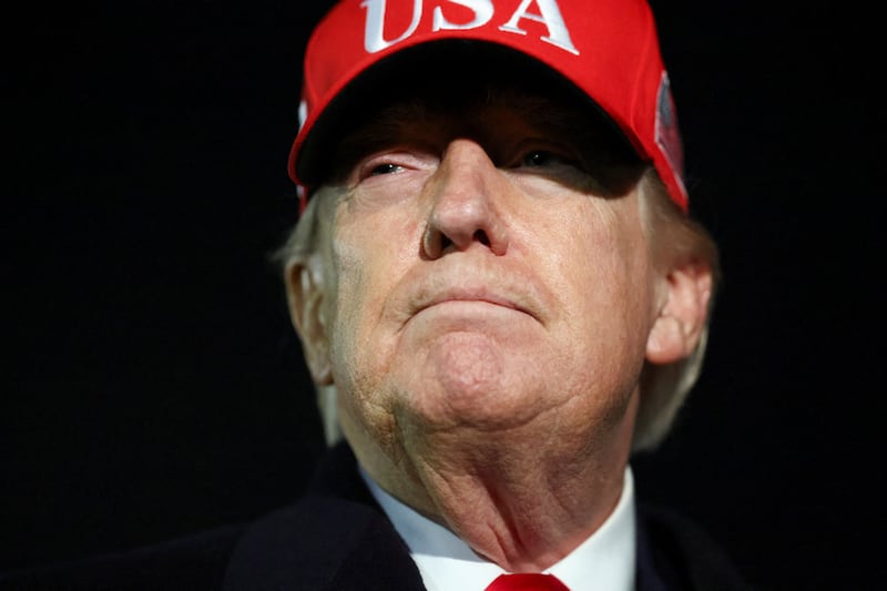President Donald Trump looks on after disembarking Air Force One as he arrives at Joint Base Andrews in Maryland, U.S., April 12, 2026.