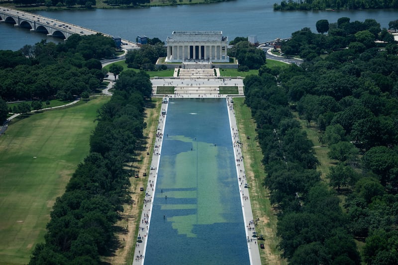 In an aerial view from the Washington Monument, crews remove algae from the bottom of the Lincoln Memorial Reflecting Pool after recent renovations following a directive from U.S. President Donald Trump to paint it blue ahead of the 250th anniversary of U.S. independence, in Washington, D.C., U.S., June 19, 2026. REUTERS/Aaron Schwartz