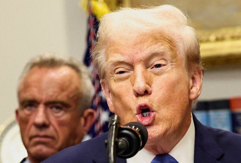 FILE PHOTO: U.S. President Donald Trump, in front of U.S. Secretary of Health and Human Services Robert F. Kennedy Jr., delivers remarks linking autism to childhood vaccines and to the use of popular pain medication Tylenol for pregnant women and children, claims which are not backed by decades of science, at the White House in Washington, D.C., U.S., September 22, 2025.