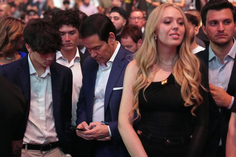 U.S. Secretary of State Marco Rubio looks at his phone, as Tiffany Trump and her husband Michael Boulos look toward the ring during the UFC 327 at Kaseya Center in Miami, Florida, U.S., April 11, 2026. Julia Demaree Nikhinson/Pool via REUTERS