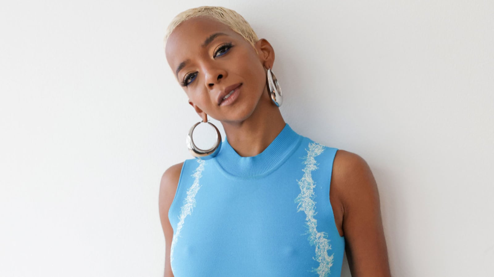 A portrait of Kara Young wearing a blue dress.