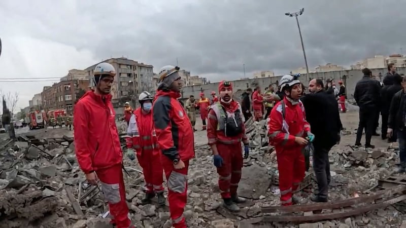 Members of the Iranian Red Crescent Society work at the site of a reported strike, amid the U.S.-Israeli conflict with Iran, in Tehran, Iran, in this screengrab taken from a handout video released on March 31, 2026. IRANIAN RED CRESCENT SOCIETY/Handout via REUTERS    THIS IMAGE HAS BEEN SUPPLIED BY A THIRD PARTY. NO RESALES. NO ARCHIVES. MANDATORY CREDIT  VERIFICATION: - Reuters verified the location from the buildings, road layout, wall and trees seen in the video, which matched satellite imagery of the area. Coordinates of damaged buildings 35.728125446176314, 51.38131951366715.  - The exact date when the video was filmed was not verified but no older version of the video was found posted online before March 31.  - Iranian media said Tehran was hit by waves of air strikes overnight on March 31.