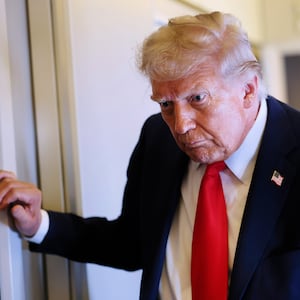 President Donald Trump speaks to reporters on Air Force One on September 18, 2025 during a flight to Joint Base Andrews, Maryland.