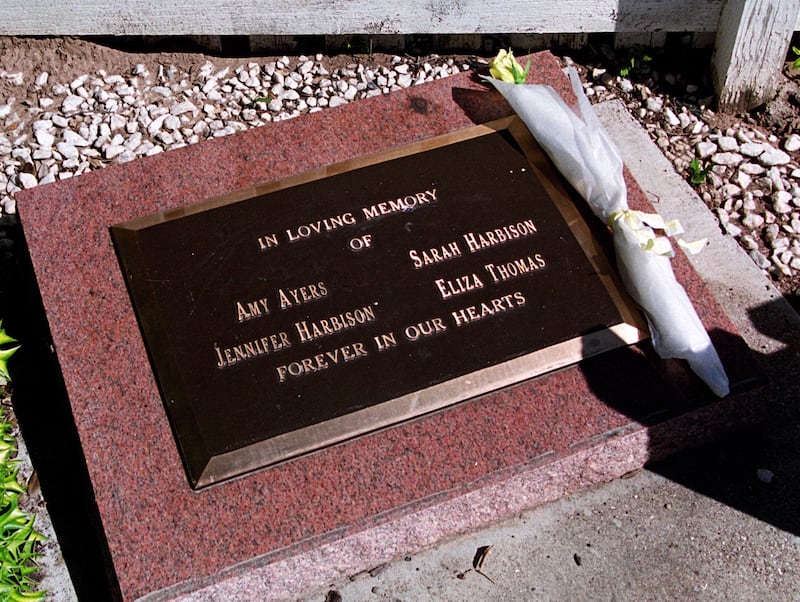 AUSTIN, TEXAS - JANUARY 23: A newly placed yellow rose sits on the memorial for the four victims of the Yogurt shop murders on Anderson Lane.