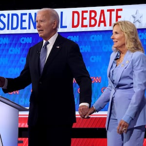 U.S. President Joe Biden walks off with first lady Jill Biden following the CNN Presidential Debate at the CNN Studios