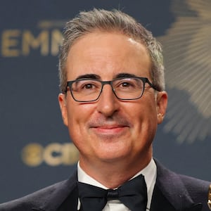 John Oliver poses with the awards for Best Scripted Variety Series and Best Writing for a Variety Series