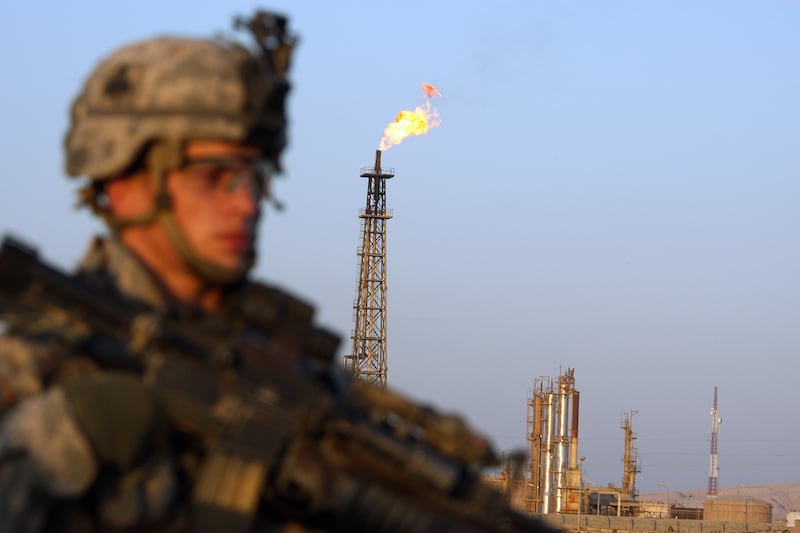 A US soldier with the 101st Airborne Division stands guard in front of the Iraqi Northern Oil Refinery near the town of Baiji, 10 November 2007, during an operation to search for weapons caches. US and Iraqi forces have launched a massive assault targeting Al-Qaeda fighters, codenamed "Task Force Iron", in four northern provinces of Iraq, the US military said. AFP PHOTO/PATRICK BAZ (Photo credit should read PATRICK BAZ/AFP via Getty Images)