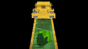 Reflecting Pool covered in algae looking like Donald Trump's head and the lincoln memorial gold