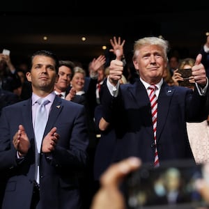 Donald Trump (C) gives two thumbs up as Donald Trump Jr. (L) looks on in 2016.