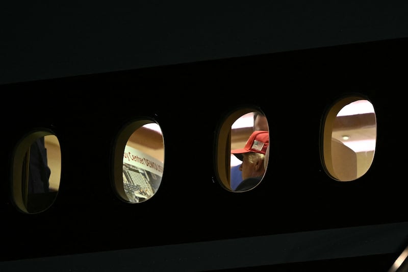President Donald Trump is seen aboard Air Force One checking a Kennedy Center large printout after landing at Joint Base Andrews, Maryland on September 16, 2026.