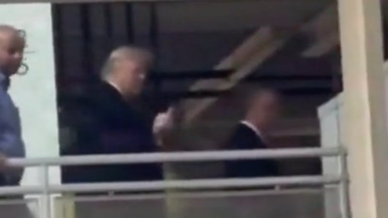 Donald Trump points and flips the bird at someone who called him a "pedophile protector" in Michigan.