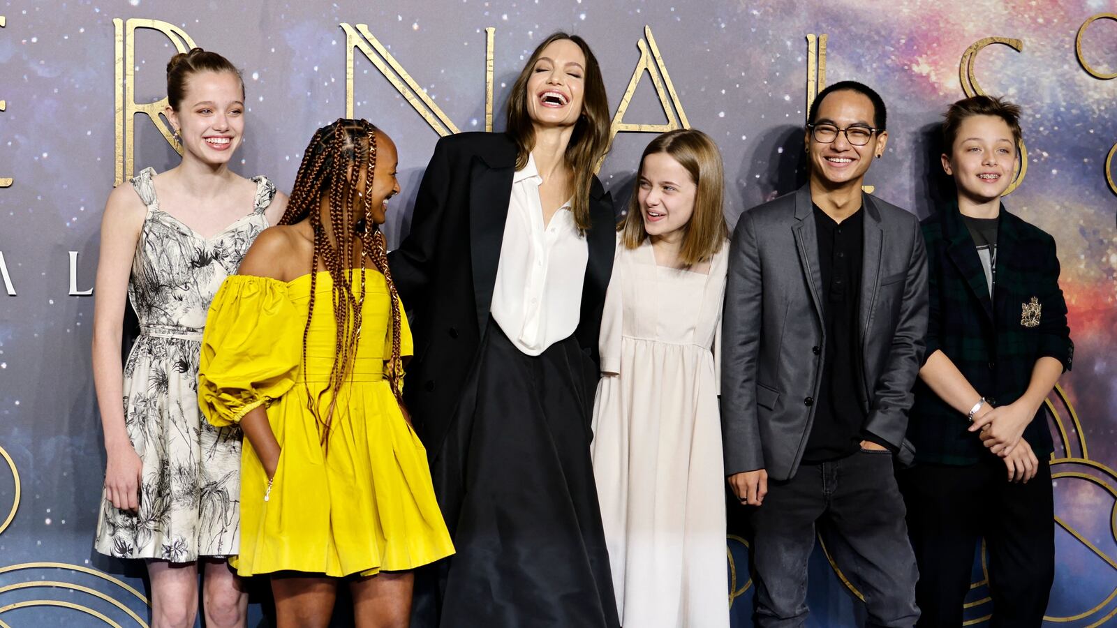 Angelina Jolie (3rd L) poses with her children, (L-R) Shiloh Jolie-Pitt, Zahara Jolie-Pitt, Vivienne Jolie-Pitt, Maddox Jolie-Pitt and Knox Jolie-Pitton on the blue carpet on arrival to attend the UK Gala Screening of the film 'Eternals', at the BFI IMAX in London on October 27, 2021.