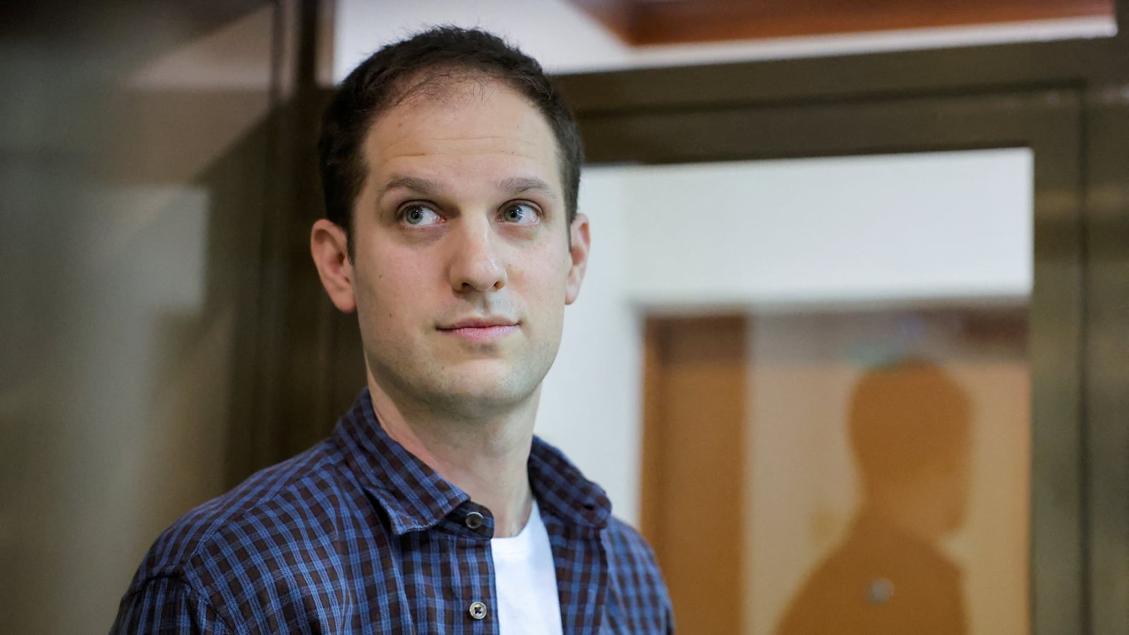Wall Street Journal reporter Evan Gershkovich stands inside an enclosure for defendants before a court hearing to consider an appeal against his pre-trial detention on espionage charges in Moscow, Russia, October 10, 2023.