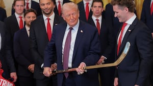 WASHINGTON, DC - JANUARY 15: Aleksander Barkov (L) and Matthew Tkachuk (R) of the Florida Panthers present U.S. President Donald Trump (C) with a jersey and hockey stick during a ceremony to honor the 2025 Stanley Cup Champion Florida Panthers in the East Room of the White House on January 15, 2026 in Washington, DC. The Florida Panthers defeated the Edmonton Oilers for the second straight year in their first-ever championships since joining the NHL in 1993. (Photo by Anna Moneymaker/Getty Images)