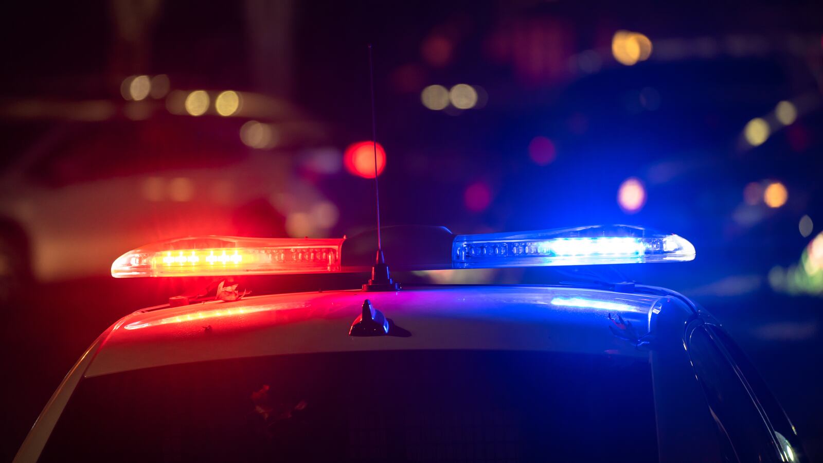 Police car with flashing lights on at night