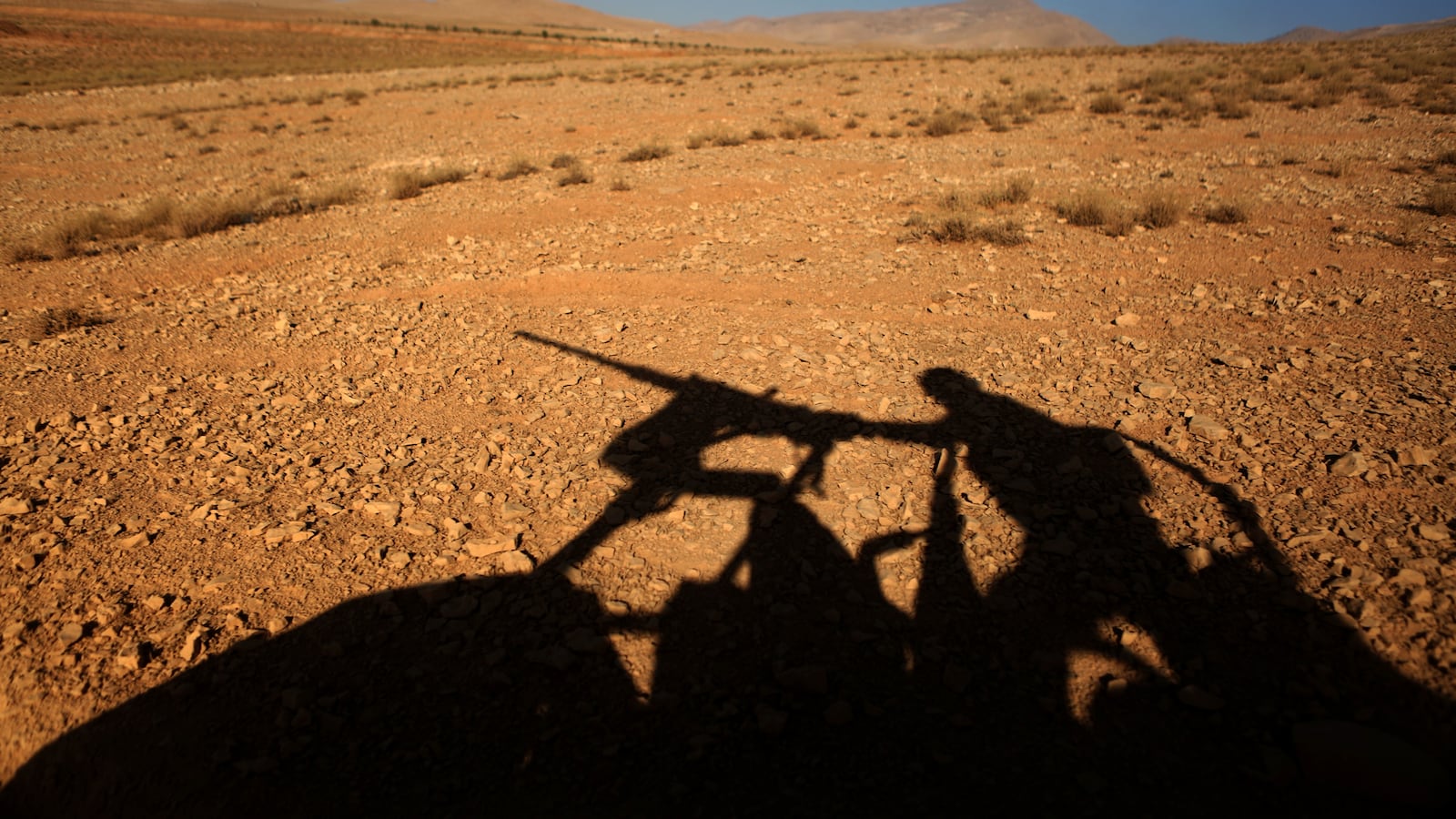 A picture taken on an army-organized press tour shows the silhouette of a Lebanese army soldier manning a machine gun on a hill they recently took from the Islamic State (IS) group in Jurud Ras Baalbek on the Lebanese-Syrian border on August 28, 2017