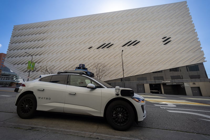 Los Angeles, CA - March 11: (EDS NOTE-NEWS EMBARGO UNTIL WEDNESDAY) A Waymo robotaxi Jaguar I-PACEs driverless car parks next to The Broad in downtown Los Angeles Monday, March 11, 2024. Waymo is about to announce the release of their robotaxi fleet across Los Angeles. The new service will allow users to go from downtown to Santa Monica, covering hundreds of miles. The service is expected to start this week but won't be available for all for a few more weeks. Waymo One fleet consists of fully electric Jaguar I-PACEs the world's first premium electric autonomously driven vehicle. The Waymo Driver uses fully autonomous technology that is always in control of the vehicle from pickup to destination. (Allen J. Schaben / Los Angeles Times via Getty Images)