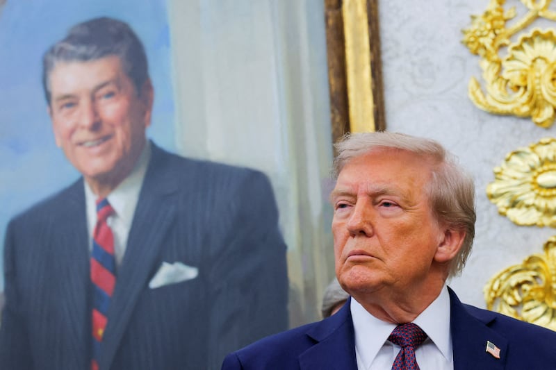 U.S. President Donald Trump, in front of a painting of former U.S. President Ronald Reagan, attends an event to announce that the Space Force Command will move from Colorado to Alabama, in the Oval Office at the White House in Washington, D.C., U.S., September 2, 2025.