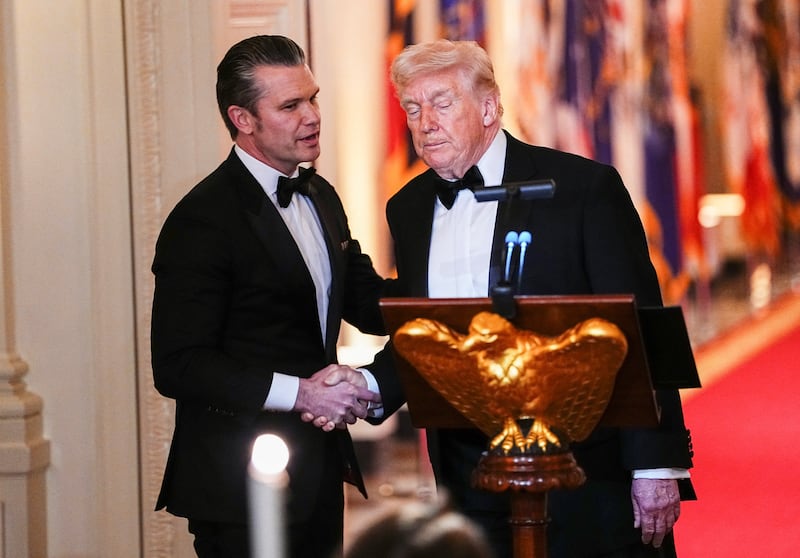 U.S. Secretary of Defense Pete Hegseth and U.S. President Donald Trump  shake hands during a Governors Dinner at the White House in Washington D.C., U.S., February 21, 2026.