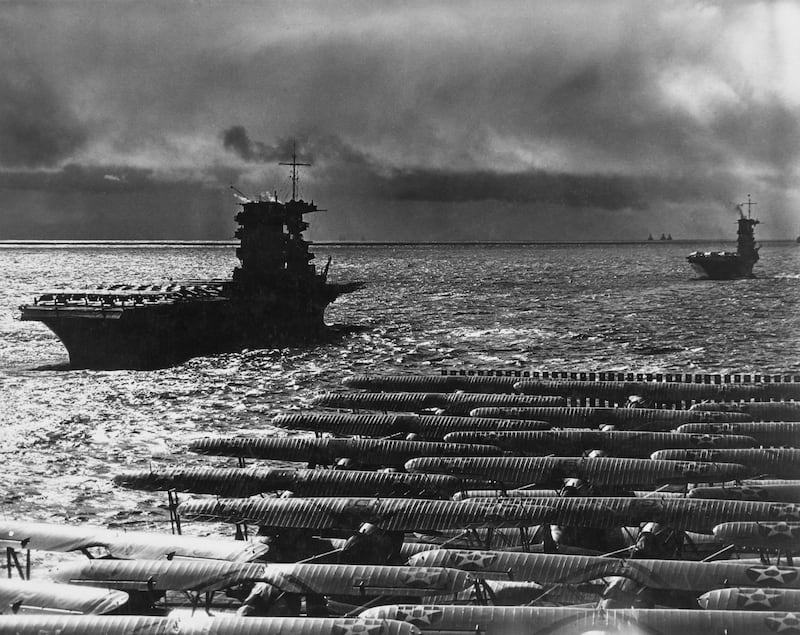 In the foreground, Grumman F3F biplane fighter aircraft sit on the flight deck of the United States Navy aircraft carrier USS Ranger (CV-4) cruising behind the USS Lexington (CV-2) and USS Saratoga (CV-3) in the Pacific Ocean during exercise Fleet Problem XIX on 8th April 1938 off Honolulu, Hawaii, United States. (Photo by FPG/Archive Photos/Getty Images).