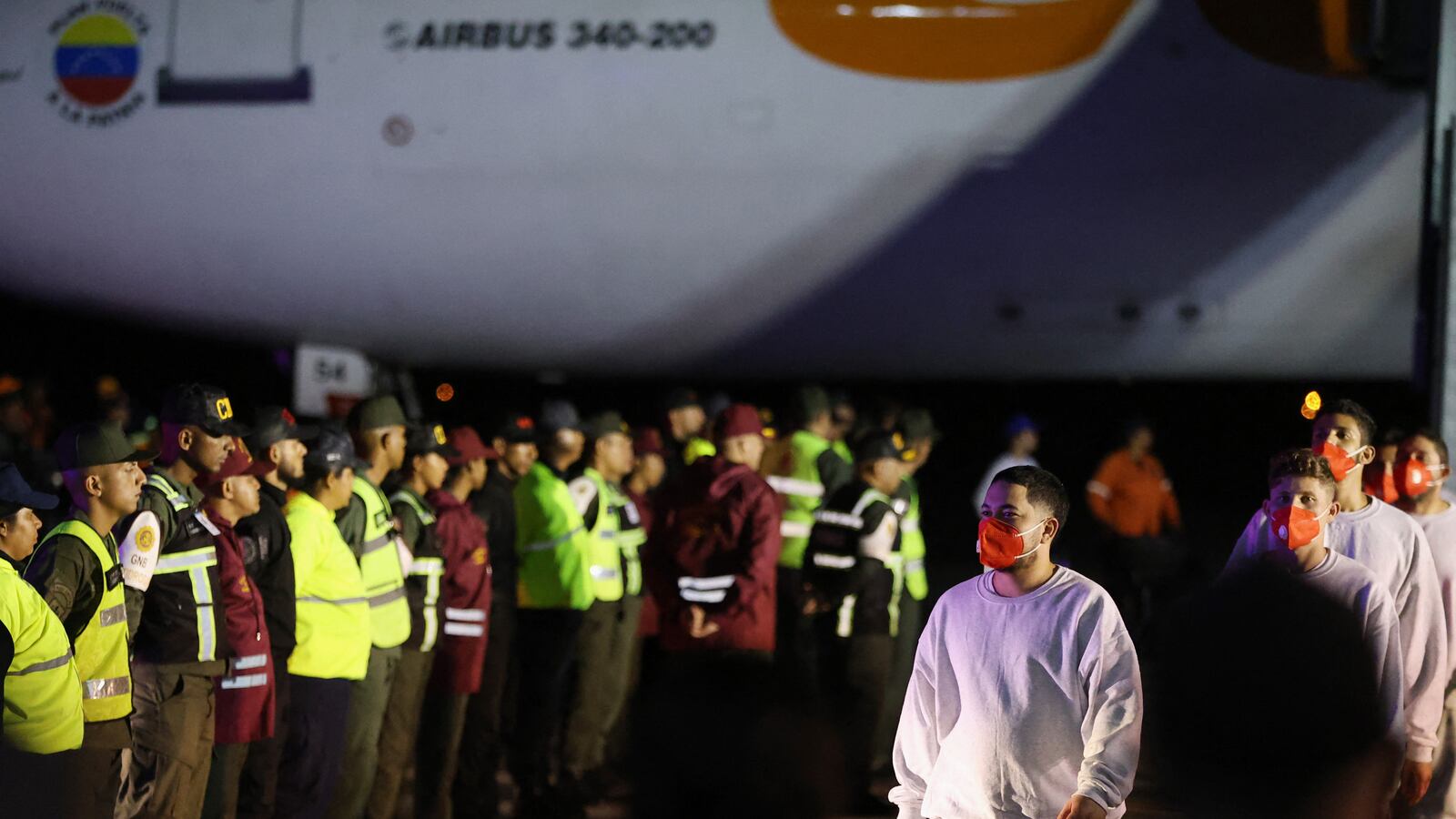 Venezuelan migrants deported from US Naval Station Guantanamo Bay walk down from the Venezuelan Conviasa Airlines plane as they arrive at Simon Bolivar International Airport in Maiquetia, Venezuela on February 20, 2025.