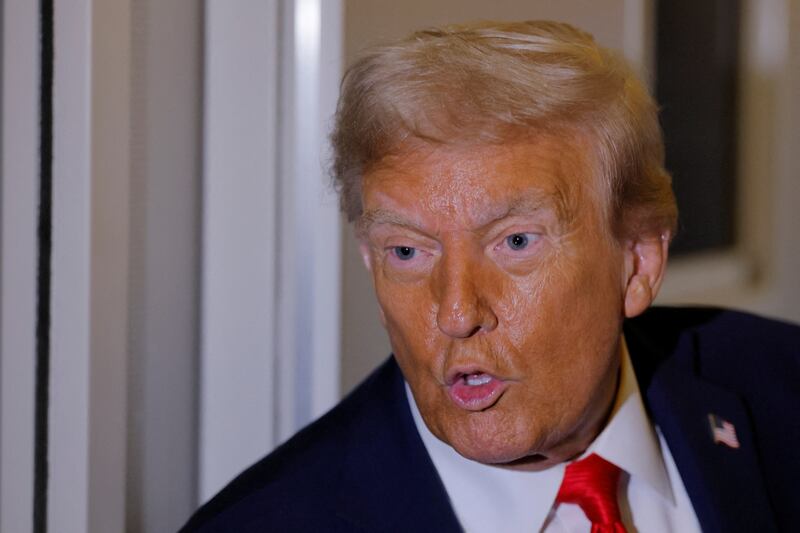 U.S. President Donald Trump answers a question from a reporter onboard Air Force One after attending the memorial service for slain conservative commentator Charlie Kirk, enroute to Joint Base Andrews, in Maryland, U.S. September 21, 2025. REUTERS/Brian Snyder