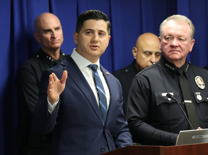 First Assistant United States Attorney Bill Essayli, center, speaks as Los Angeles Police Chief Jim McDonnell, right, and other law enforcement officials listen during a news conference announcing the arrests of twelve 18th Street gang members accused of running a drug trafficking operation in the MacArthur Park area at the U.S. Courthouse in Los Angeles Thursday, March 5, 2026.