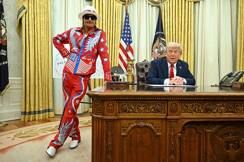 US President Donald Trump signs an executive order alongside US singer Kid Rock in the Oval Office of the White House in Washington, DC, on March 31, 2025. (Photo by SAUL LOEB / AFP) (Photo by SAUL LOEB/AFP via Getty Images)