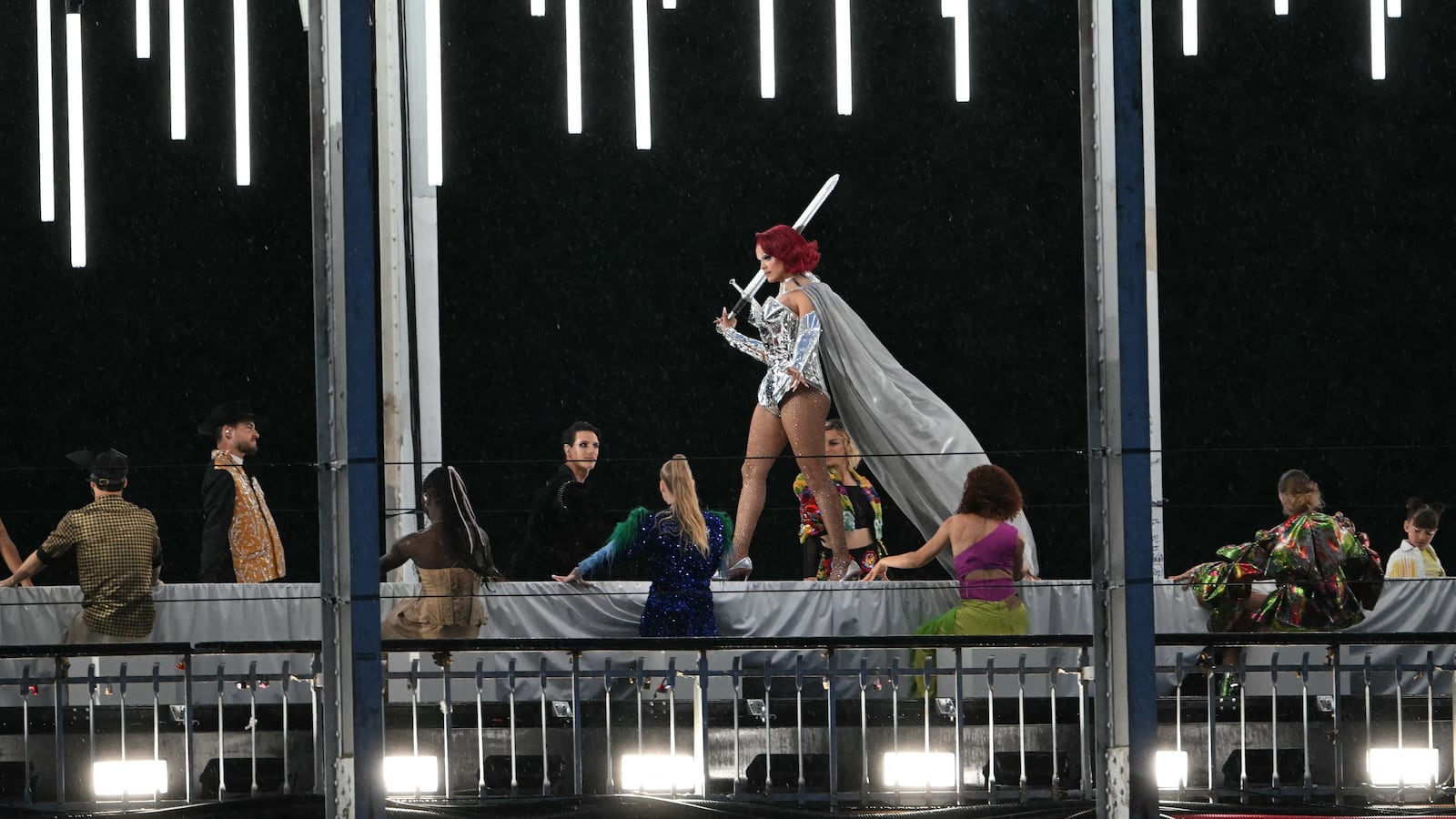 A model walking on a catwalk during the Olympics opening ceremony in Paris.