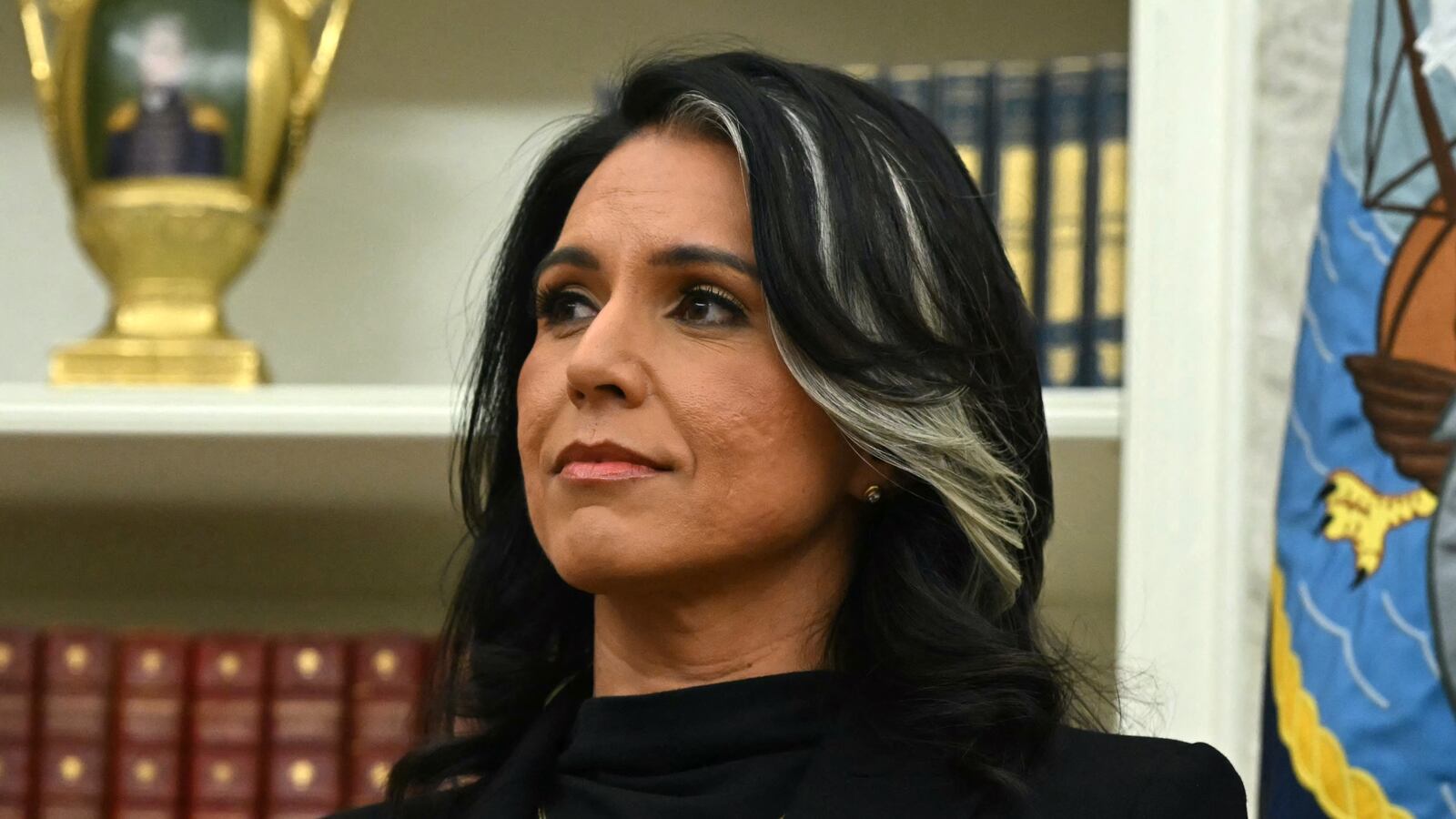 Tulsi Gabbard waits to be sworn in as Director of National Intelligence (DNI) in the Oval Office of the White House in Washington, DC, on February 12, 2025. The Republican-controlled US Senate confirmed Tulsi Gabbard earlier as Trump's choice to lead the country's intelligence services, despite criticism over her lack of experience and past support for Russia and Syria. Gabbard -- appointed to be director of national intelligence -- has faced questions over her 2017 meeting with now-deposed Syrian leader Bashar al-Assad and her peddling of Kremlin propaganda, particularly false conspiracy theories about the Ukraine war. She is also regarded with suspicion over her views on US government surveillance and her backing for National Security Agency (NSA) leaker Edward Snowden, seen on both sides of Congress as having imperiled Americans' safety. (Photo by ANDREW CABALLERO-REYNOLDS / AFP) (Photo by ANDREW CABALLERO-REYNOLDS/AFP via Getty Images)