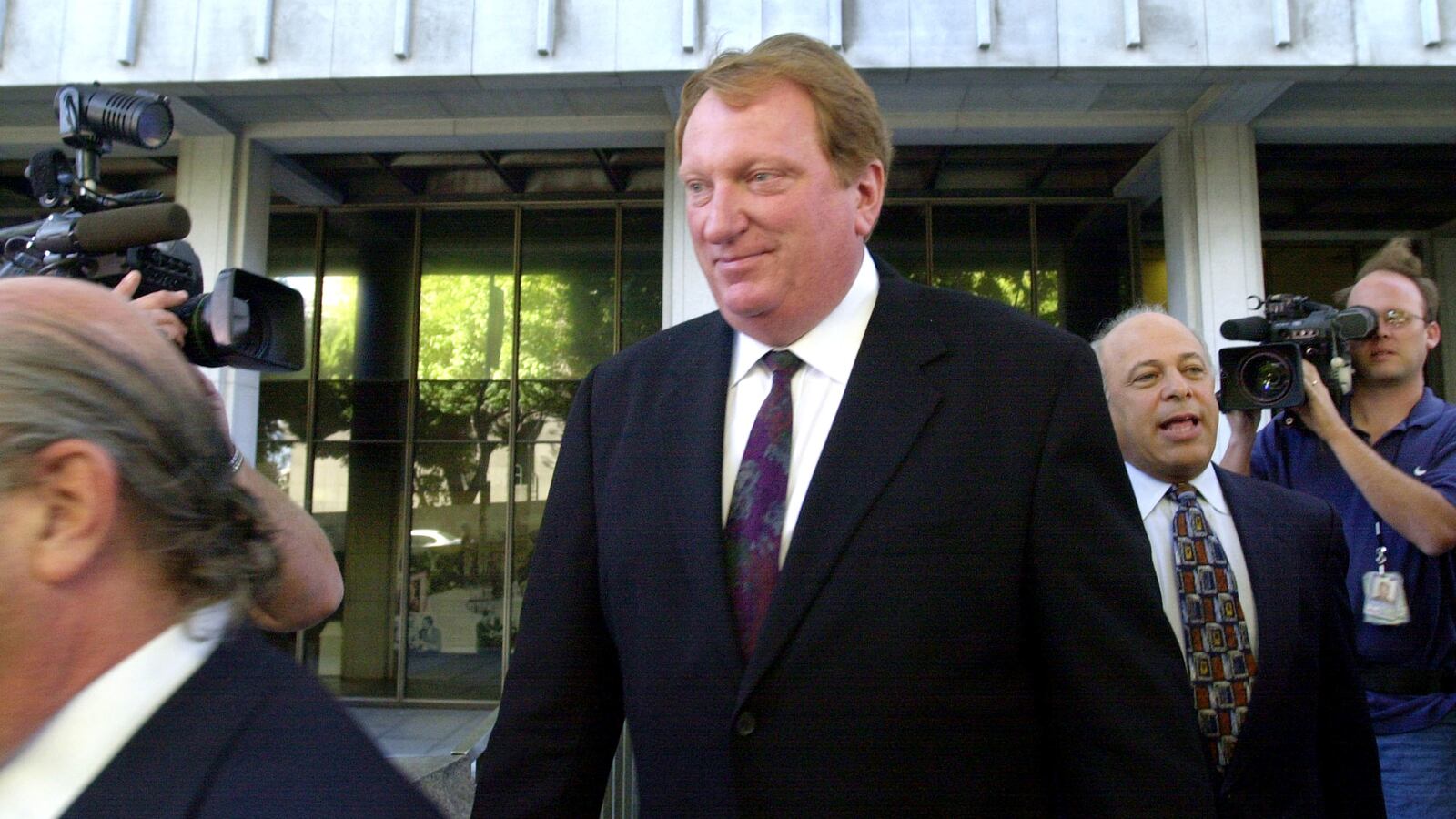 Actor Jeffery Jones (C) exits Los Angeles Superior Court house after his 2002 arraignment for hiring a teenage boy to pose for sexually explicit photographs and for possession of child pornography.
