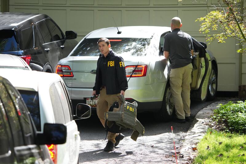 FBI agents work outside the home of John Bolton, former national security adviser to President Trump, August 22, 2025 in Bethesda, Maryland.  The FBI conducted an early morning court-authorized search of Bolton's home.