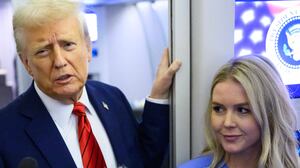 US President Donald Trump, watched by White House Press Secretary Karoline Leavitt, speaks to reporters while in flight on Air Force One en route Joint Base Andrews, on January 27, 2025. (Photo by Mandel NGAN / AFP) (Photo by MANDEL NGAN/AFP via Getty Images)