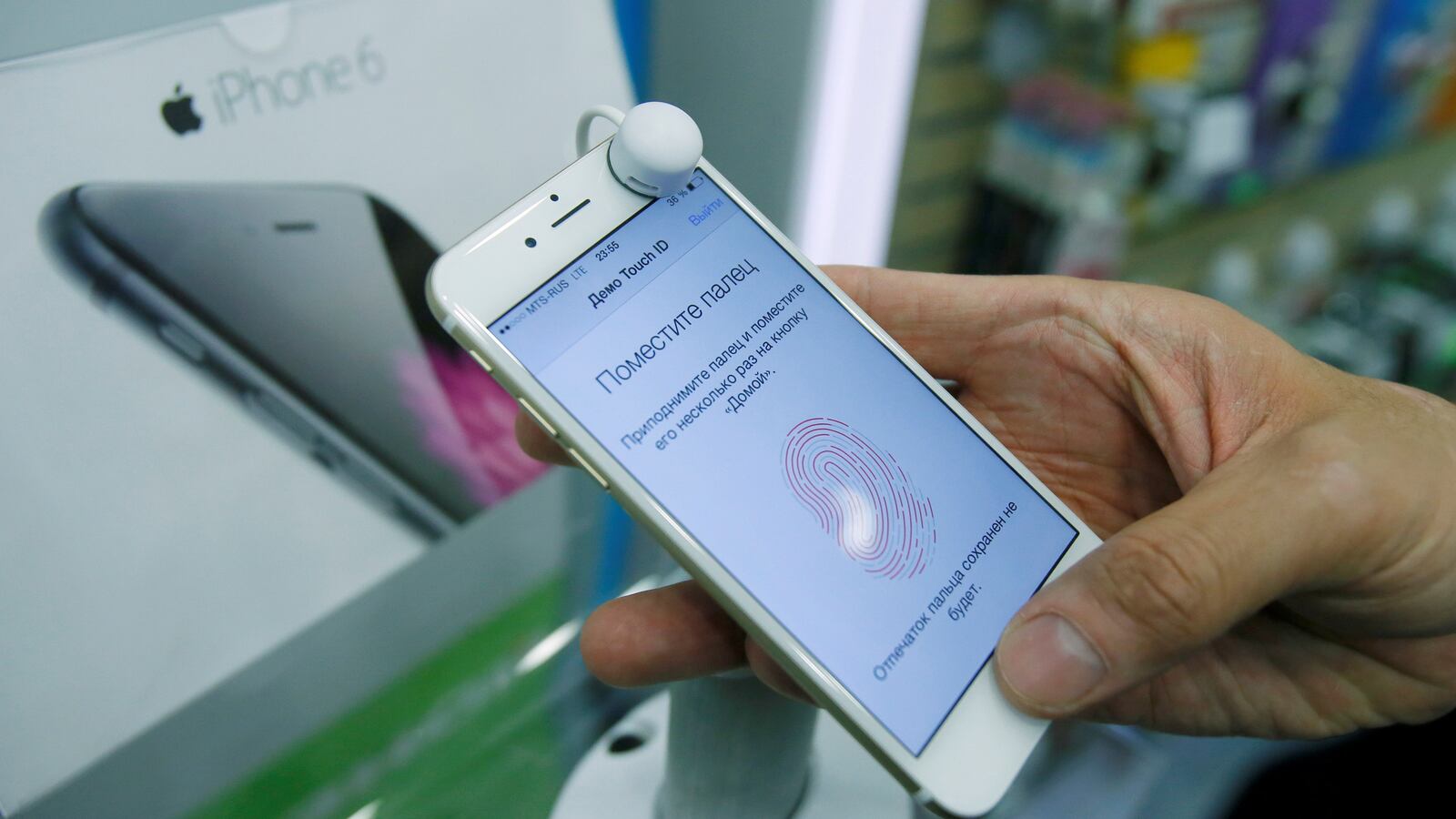 A man holds an iPhone 6 in a mobile phone shop in Moscow, Russia, Sept. 26, 2014.