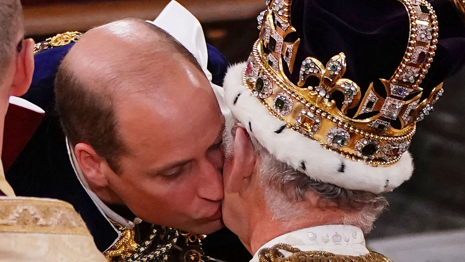 TOPSHOT - Britain's Prince William, Prince of Wales kisses his father, Britain's King Charles III, wearing St Edward's Crown, during the King's Coronation Ceremony inside Westminster Abbey in central London on May 6, 2023. The set-piece coronation is the first in Britain in 70 years, and only the second in history to be televised. Charles will be the 40th reigning monarch to be crowned at the central London church since King William I in 1066. Outside the UK, he is also king of 14 other Commonwealth countries, including Australia, Canada and New Zealand. Camilla, his second wife, will be crowned queen alongside him and be known as Queen Camilla after the ceremony. (Photo by Yui Mok / POOL / AFP) (Photo by YUI MOK/POOL/AFP via Getty Images)