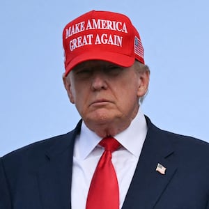 US President Donald Trump steps off Air Force One upon arrival at Joint Base Andrews in Maryland on October 30, 2025. The United States is cutting back the number of refugees to be accepted annually to a record low 7,500 and giving priority to white South Africans. The move, published in the official Federal Register on Thursday, comes after President Donald Trump essentially halted refugee arrivals after taking office in January. (Photo by ANDREW CABALLERO-REYNOLDS / AFP)