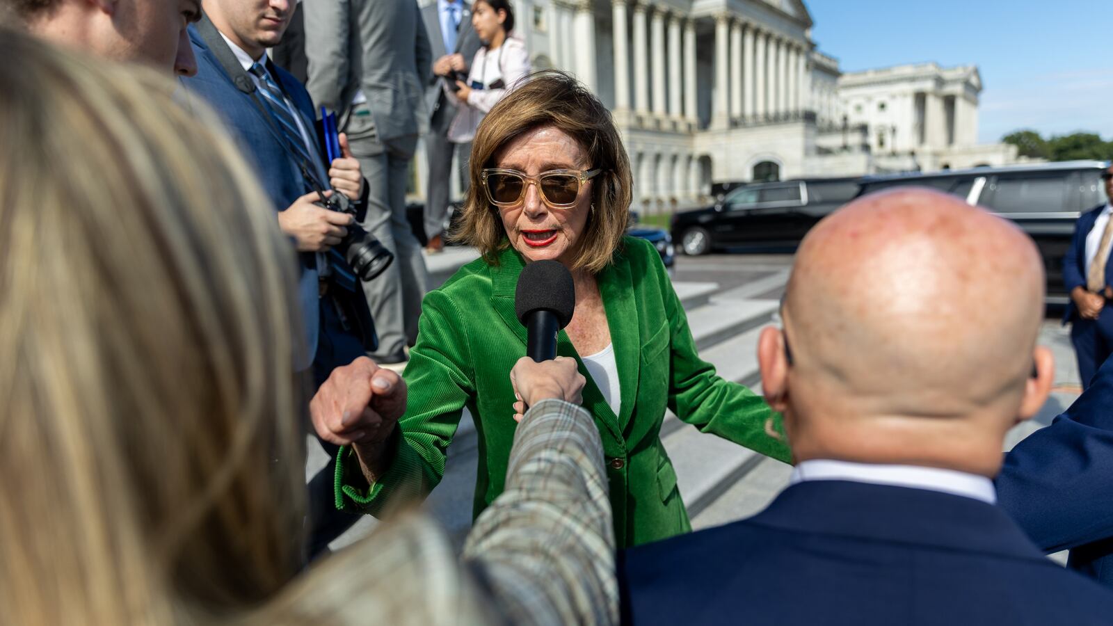 WASHINGTON, DC - OCTOBER 15: Speaker Emerita Nancy Pelosi (D-CA) responds to a question following a press conference on healthcare with other House Democrats on the East steps of the U.S. Capitol on the 15th day of the government shutdown in Washington, DC on October 15, 2025. (Photo by Nathan Posner/Anadolu via Getty Images)