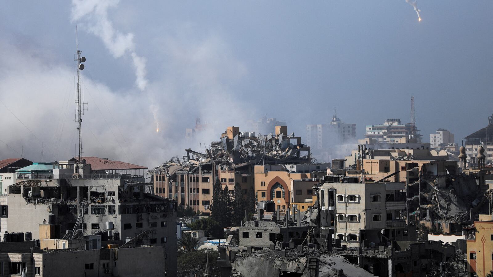Israeli forces drop smoke bombs, amid the ongoing conflict between Israel and Palestinian Islamist group Hamas, in Gaza City.