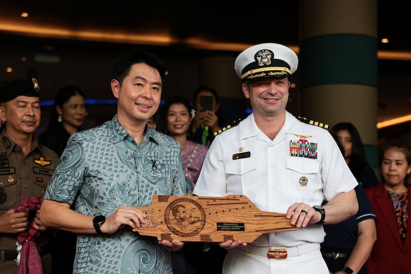 Captain Dan Keeler, USS Abraham Lincoln's commanding officer, gives a souvenir to Pattaya Mayor Poramase Ngampiches as members of the U.S. military arrive at Hard Rock Hotel Pattaya for a welcoming ceremony, in Pattaya, Thailand September 2, 2026. REUTERS/Chalinee Thirasupa