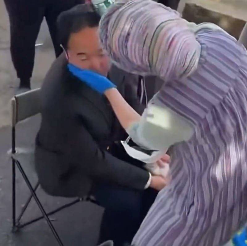Andy Kim is treated by a medic after being pepper-sprayed.