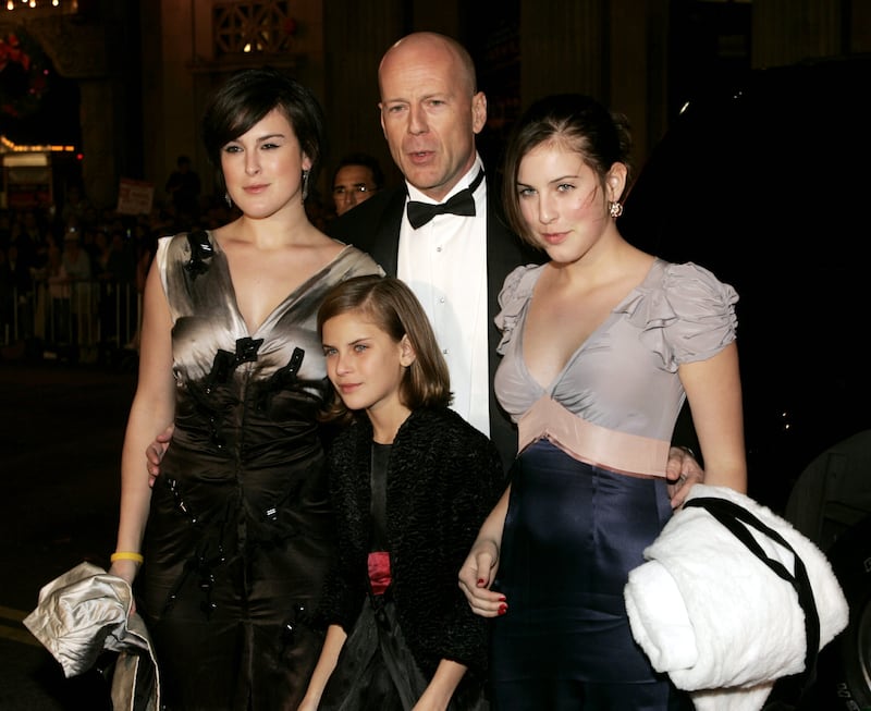 Actor Bruce Willis and his daughters (L-R) Rumer Glenn Willis,Tallulah Belle Willis and Scout LaRue Willis pose as they arrive for the "Ocean's Twelve" gala black tie premiere in Hollywood December 8, 2004. [The film directed by Steven Soderbergh and produced by Jerry Weintraub, about a group of high class thieves and their friends opens in theaters December 10.]
