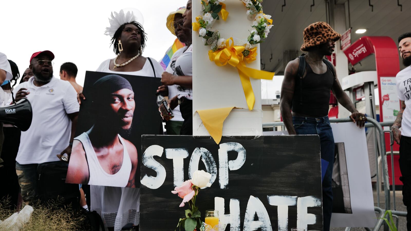 People gather at a memorial for O’Shae Sibley. A 17-year-old teenager has been charged with murder as a hate crime for the fatal stabbing of Sibley, a 28-year-old Black gay man.