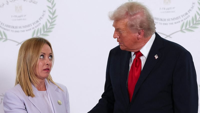 President Donald Trump and Italian Prime Minister Giorgia Meloni shake hands as they pose for a photo during a world leaders' summit on October 13, 2025 in Sharm El-Sheikh, Egypt.