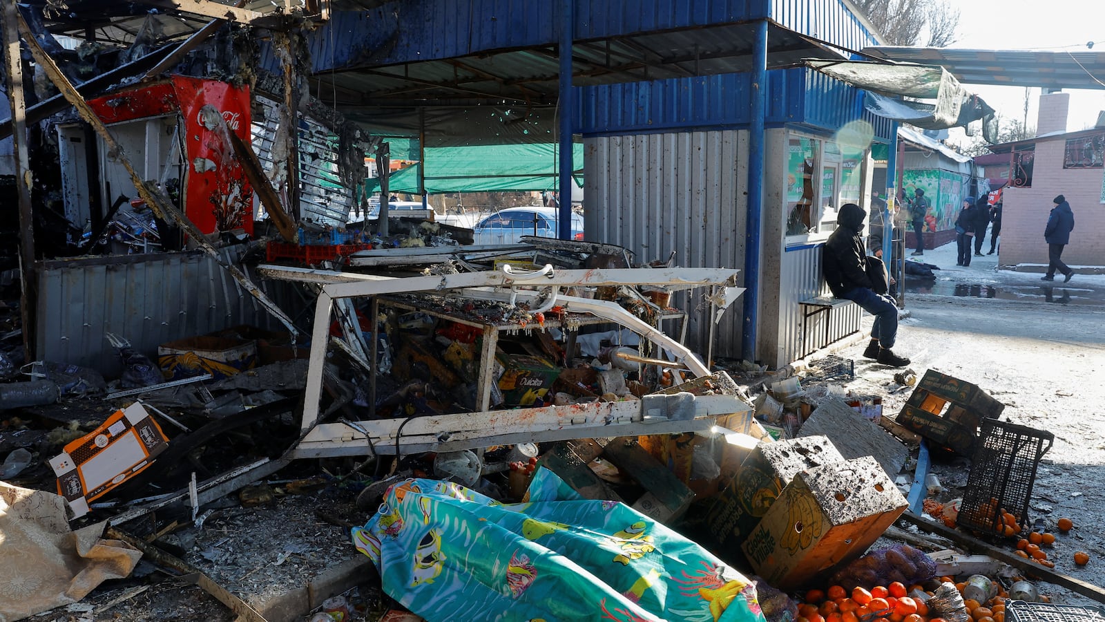 Aftermath of a deadly strike on a marketplace in Donetsk, which its Russian-backed leaders say came from Ukrainian artillery.