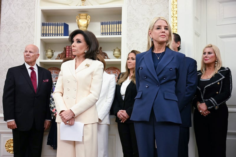 Jeanine Pirro (L) and Pam Bondi (R) look on as President Donald Trump speaks during a swearing in ceremony, in the Oval Office of the White House in Washington, DC, on May 28, 2025.