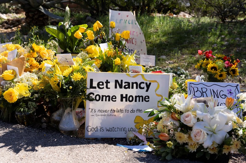 A sign pleads for the return of Nancy Guthrie shortly after her disappearance almost six months ago.