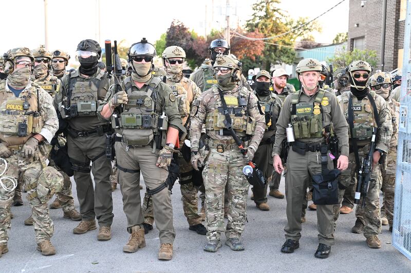 Border Patrol Chief Gregory Bovino of the El Centro Sector stands amid a protest outside an ICE facility