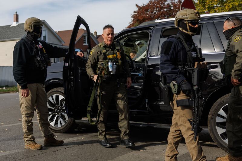 Border Patrol Cmdr. Gregory Bovino walks with other agents while conducting an immigration enforcement action.